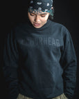 Person wearing a dark blue sweatshirt with 'WASHBOREHEAD' text on a black background