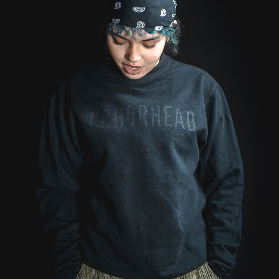 Person wearing a dark blue sweatshirt with 'WASHBOREHEAD' text on a black background