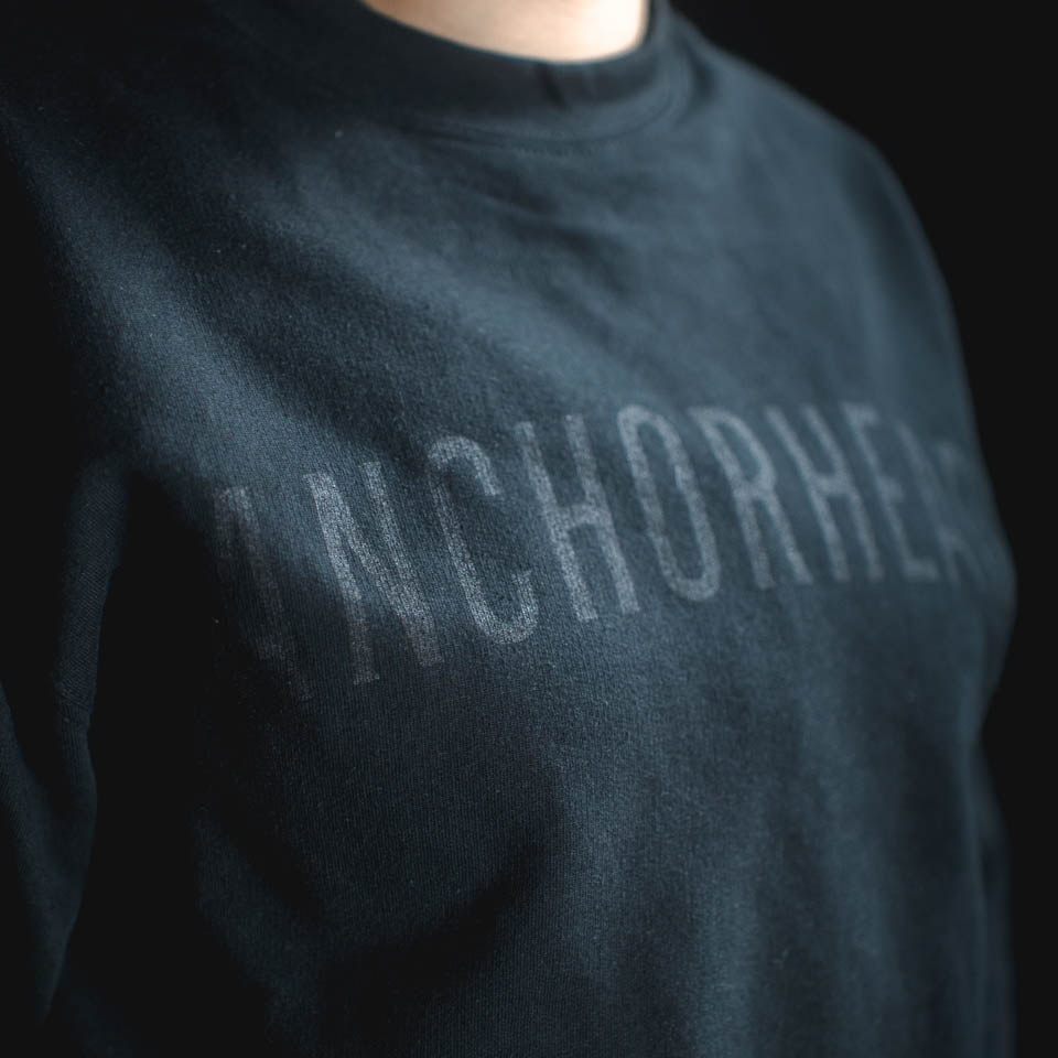 Dark gray sweatshirt with 'ANCHORHEAD' text on a black background