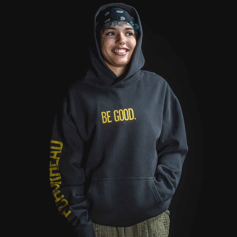 Person wearing a black hoodie with 'BE GOOD.' text on a black background