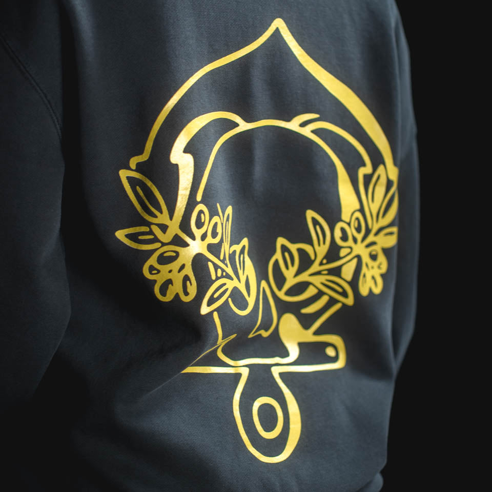 Black sweatshirt with gold floral design on a black background