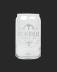 Clear glass resembling a soda can with "Anchorhead Coffee Co" and an anchor logo printed in white. Minimalistic design on a dark gray background.